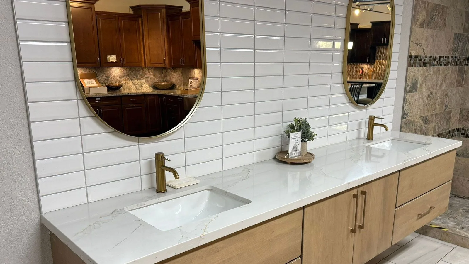 Bathroom with glossy white tile and a wood double vanity