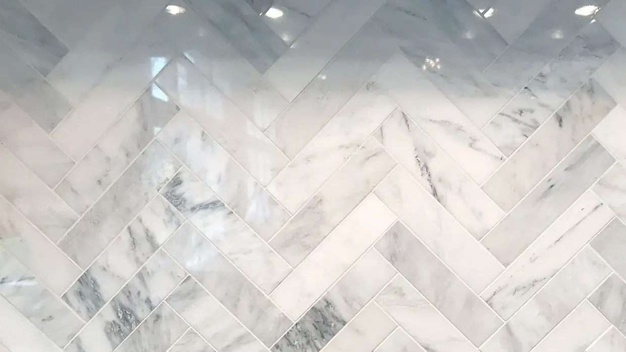 A marble backsplash in a chevron pattern.