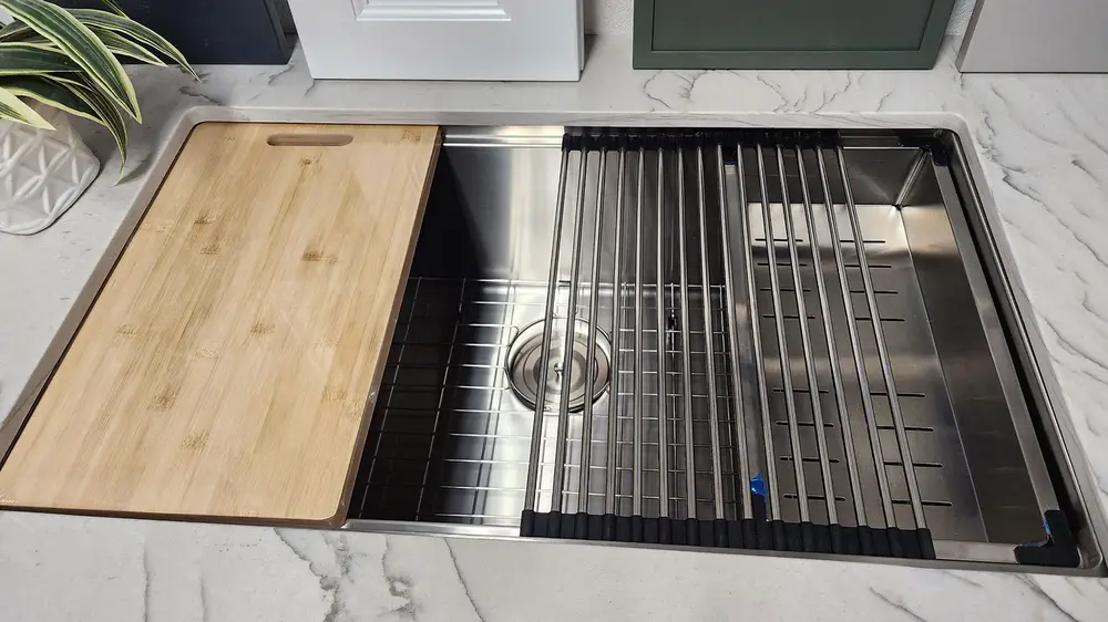 A workstation sing with drying rack and cutting board included.