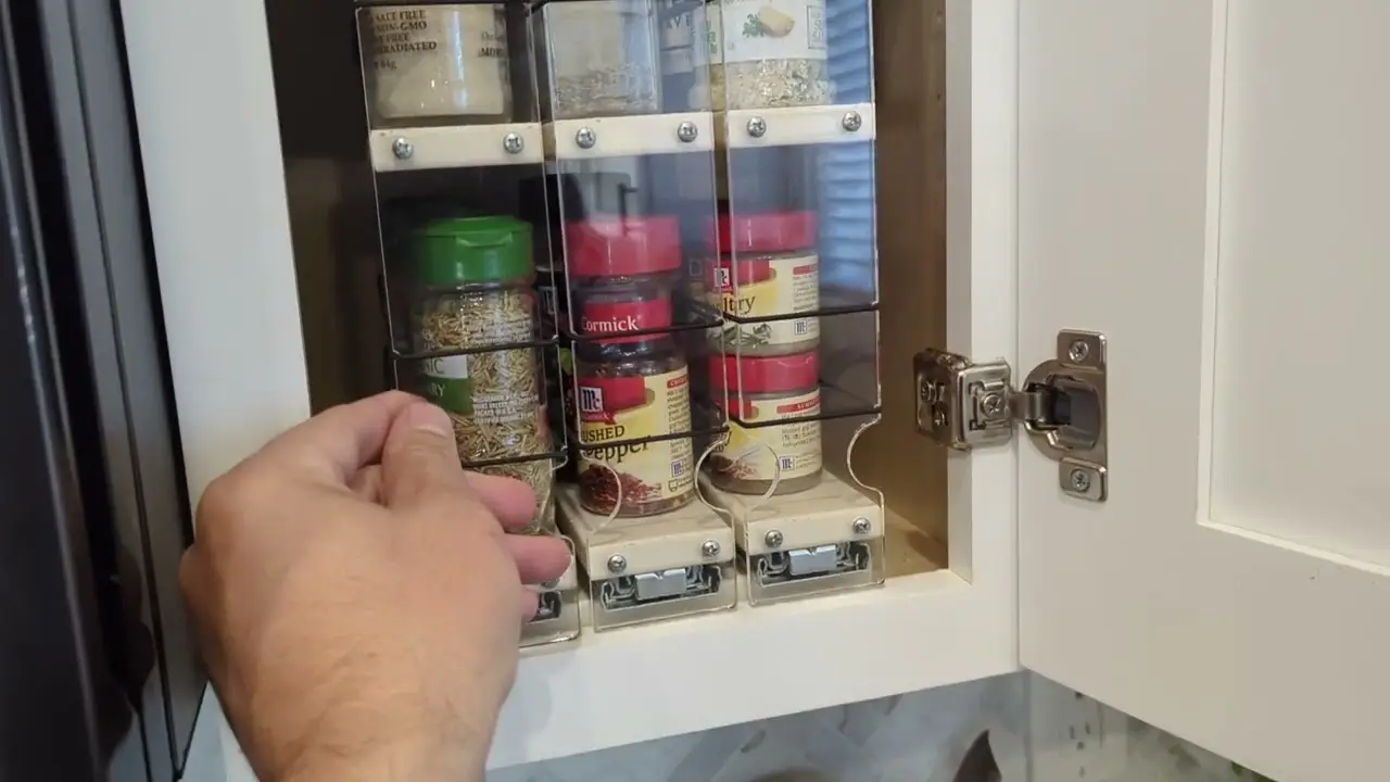 Pull-out spice rack inside a white cabinet