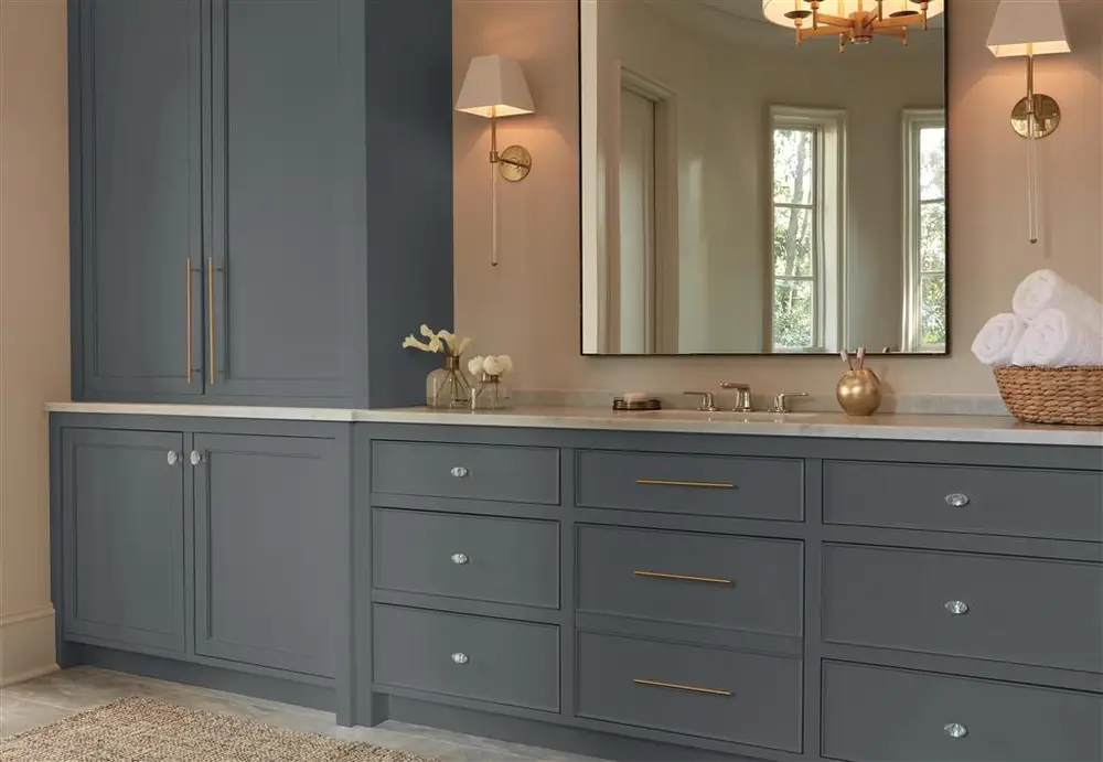 Glacio knobs and bar pulls in clear crystal and golden champagne on a bathroom vanity