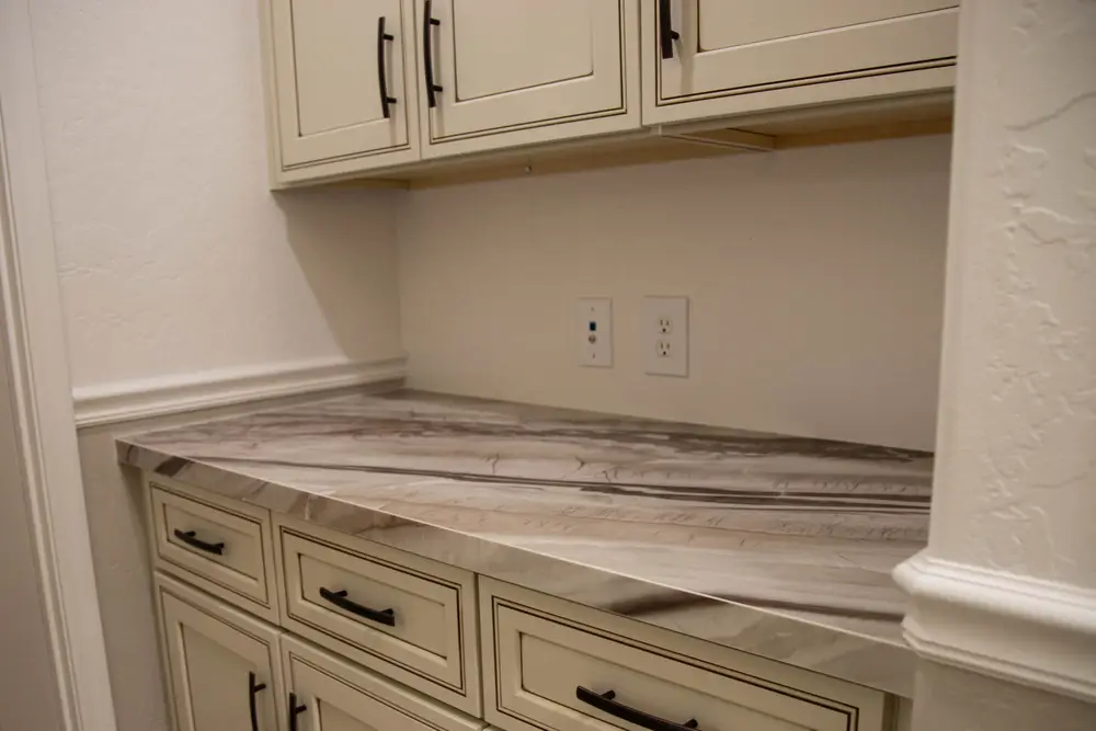 Veined countertop on cream cabinets