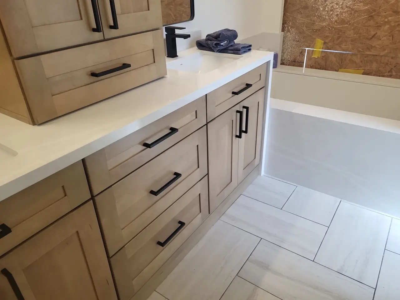 Wood shaker vanity cabinets installed in a bathroom