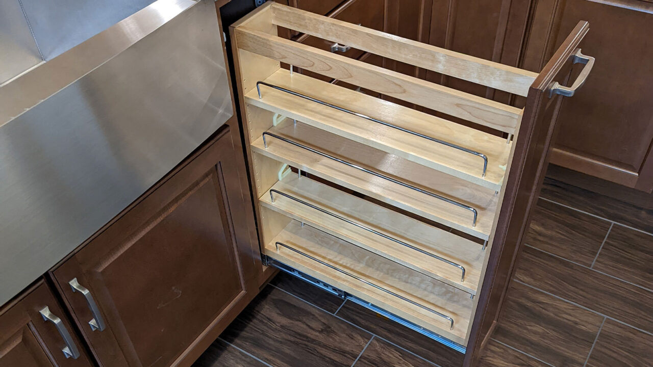A pull out cabinet organizer.